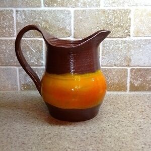 Beautiful hand made clay  pitcher brown and orange. Signed